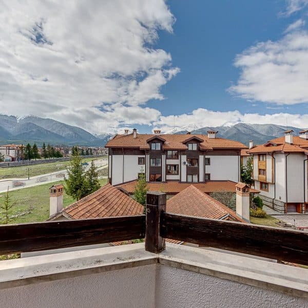 view from the mountain through the terrace of an apartment in Hotel Famil Bansko